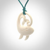 A hand carved bone whale pendant. This is a lovely piece carved to bring pleasure to the lucky wearer. It is a friendly pendant which we will ship to you free wherever you live. Carved by NZ Pacific and for sale online. Provided with an adjustable blue cord.
